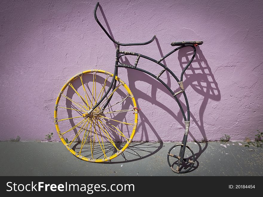 Old bike on a colorful wall and vignetting