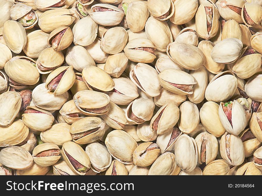 Background with many open salted pistachios. Background with many open salted pistachios