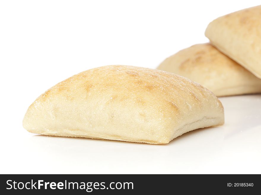 Fresh ciabatta bread against a white background