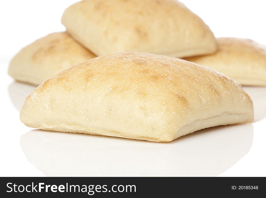 Fresh ciabatta bread against a white background