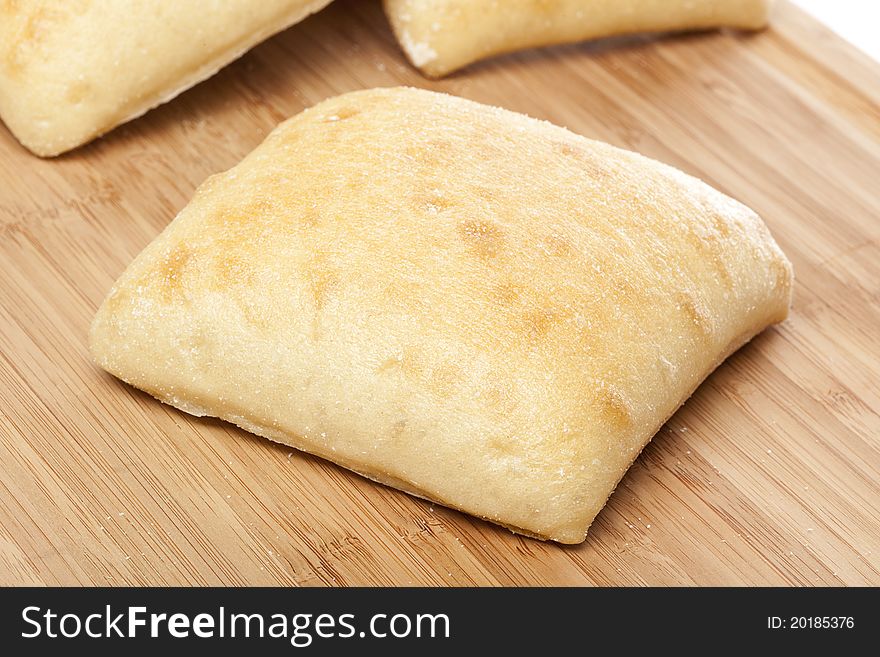 Fresh ciabatta bread against a white background