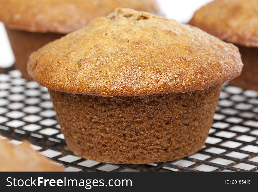 A fresh bran muffin against a white background