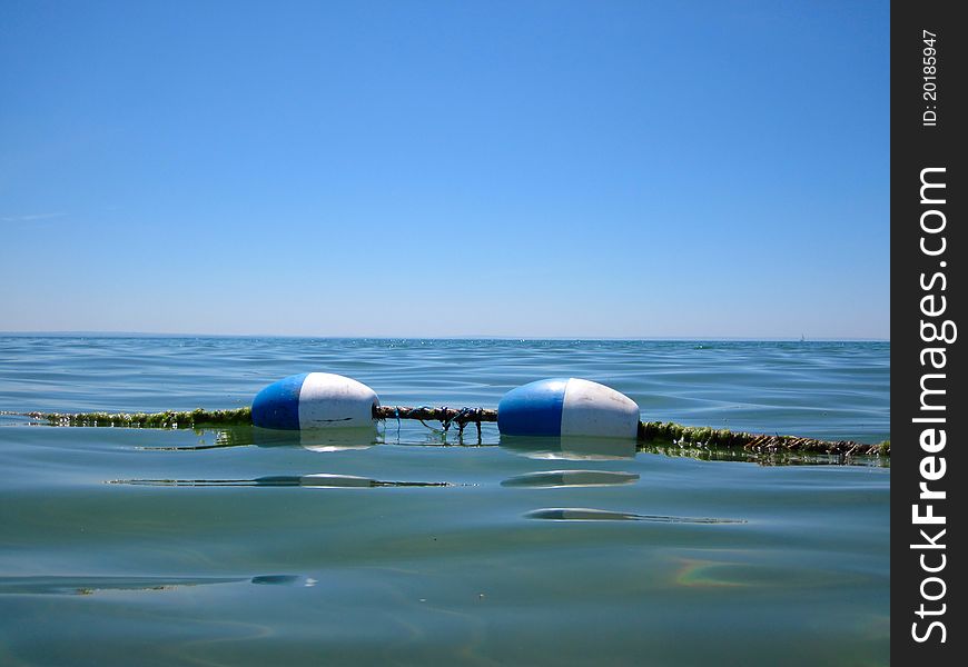 Buoy rope barrier on the water with floats