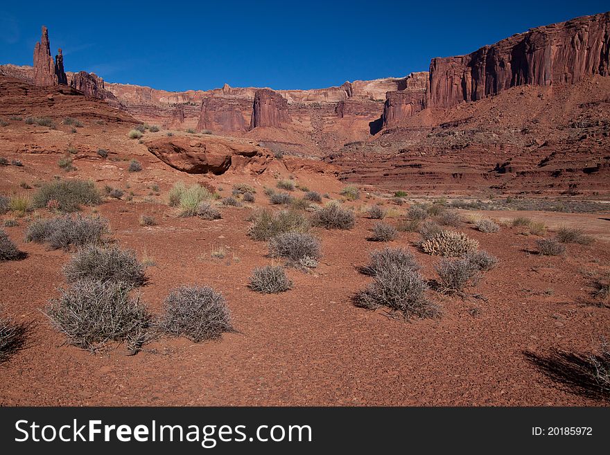 This view was captured in area along the White Rim Road near Airport camping area in the Canyonlands National Park. These massive land formations are much larger than they appear in any image. This view was captured in area along the White Rim Road near Airport camping area in the Canyonlands National Park. These massive land formations are much larger than they appear in any image.