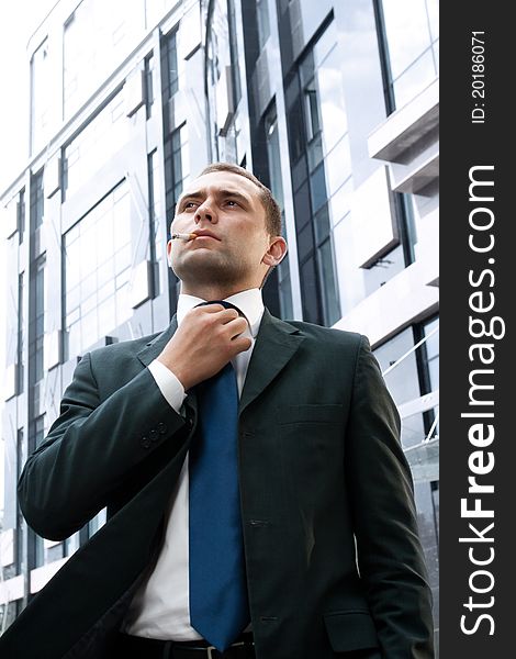 Young and successful businessman with cigarette