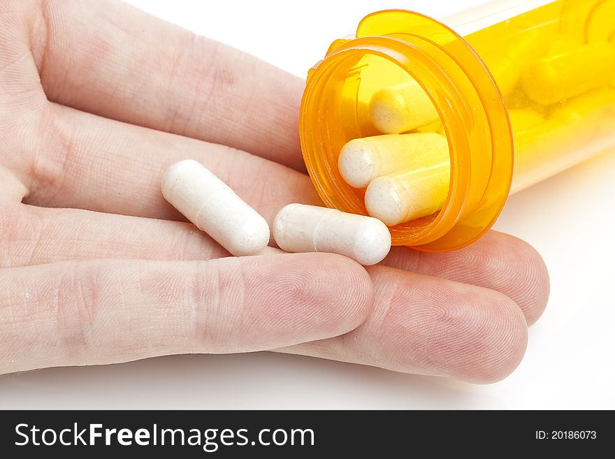 White pills pouring into a persons hand