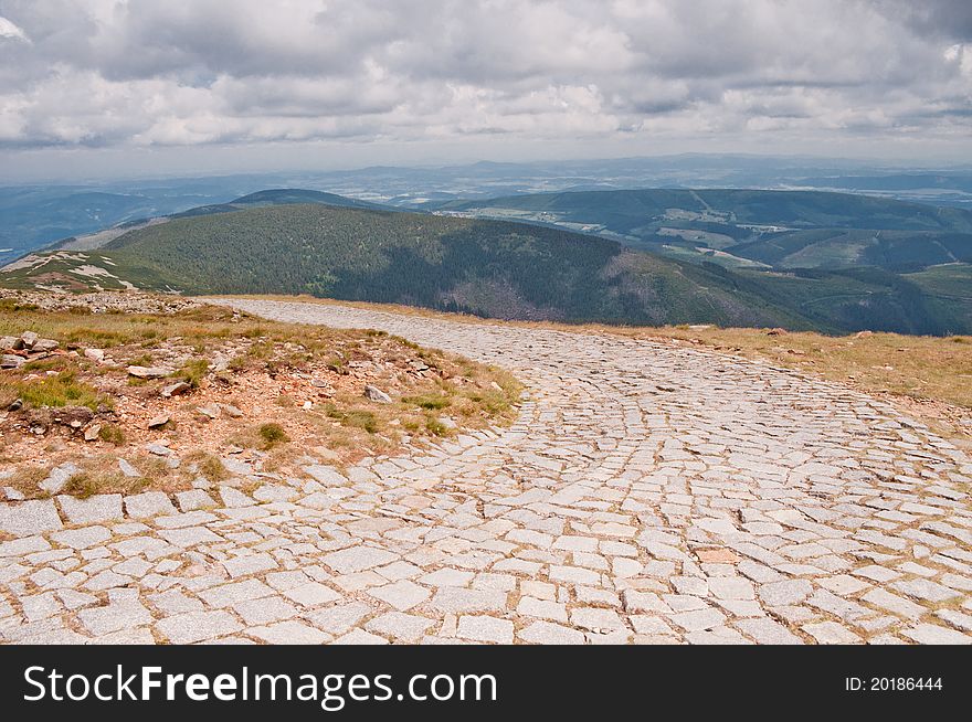 Rock climbing route and view of the mountains before the storm