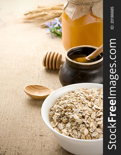 Plate of cereals and honey on wood texture