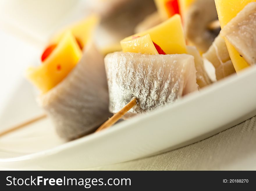 Herring rolls with cheese and pepper