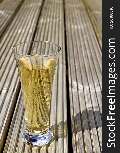 Ice cold beer on wooden decking. Ice cold beer on wooden decking