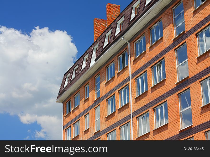 Built house of brick against the blue sky. Built house of brick against the blue sky