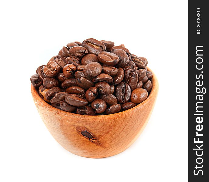 Coffee beans in a wooden platter isolated on a white background