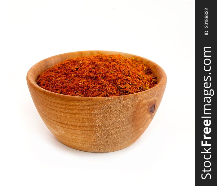 Spices in a wooden platter isolated on a white background