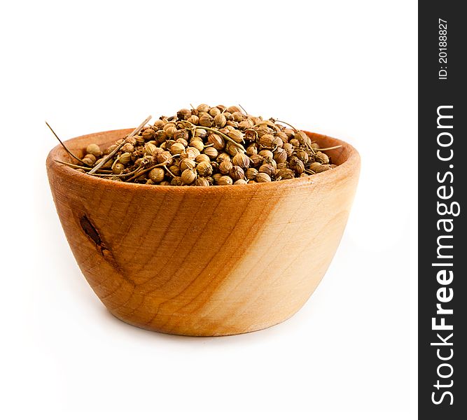 Spices in a wooden platter isolated on a white background