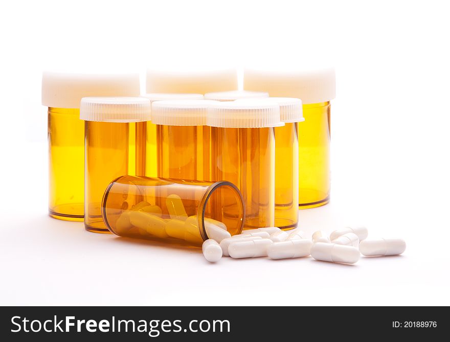 Pill Containers with White capsules inside, all on a bright white background