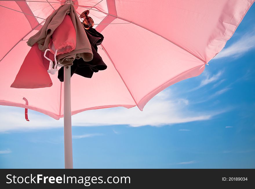 Beach umbrella with clothes attacked