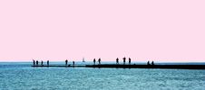 People Silhouettes On A Breakwater Royalty Free Stock Photo