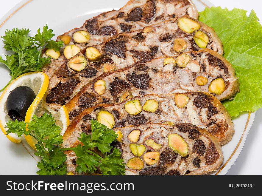 Cold appetizer meatloaf, decorated slices of lemon and lettuce