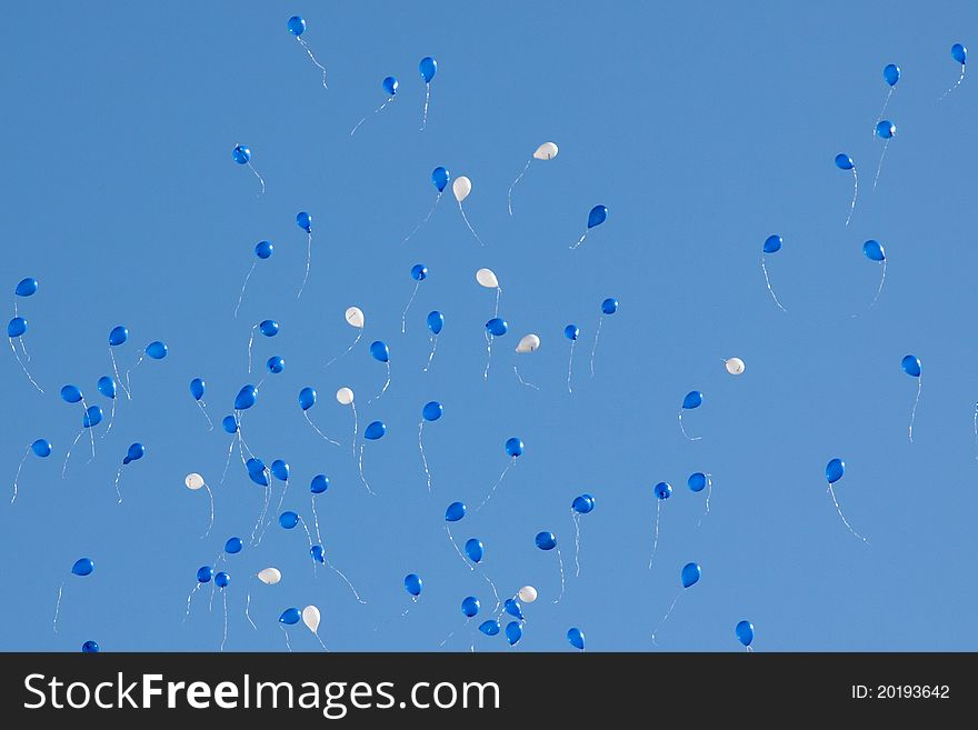 Blue and white balloons in blue sky