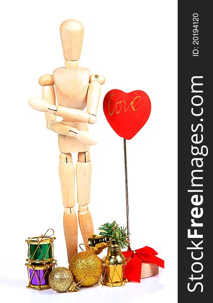 Wooden mannequin withvalentine day decorations over white background.