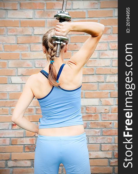 A young woman in sport wear exercising in sport club