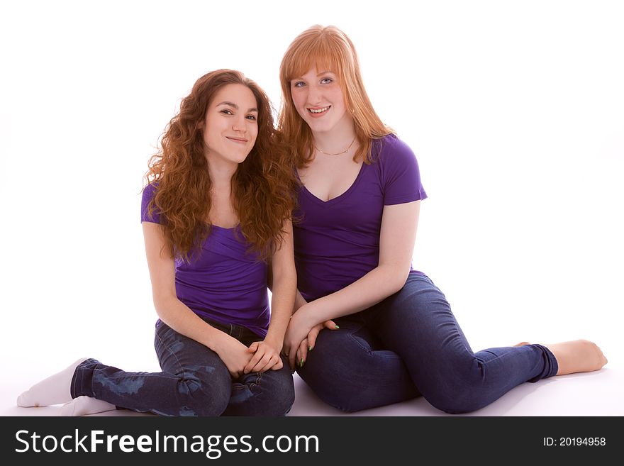 Two friends sitting side by side on the floor