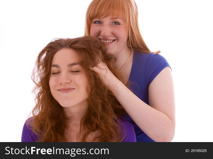A girl is massaging her friends head. A girl is massaging her friends head