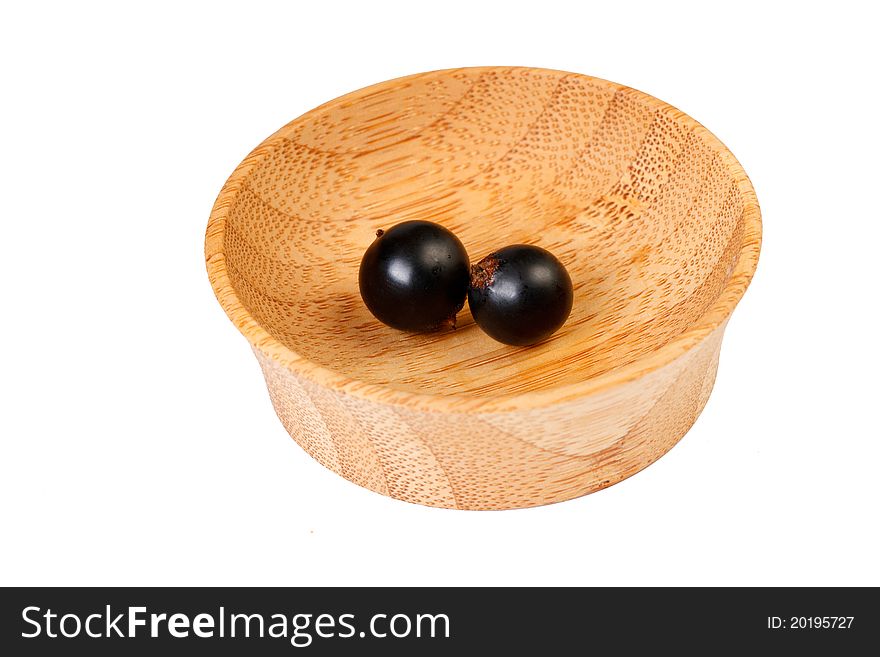 Two blackberries in a wooden bowl