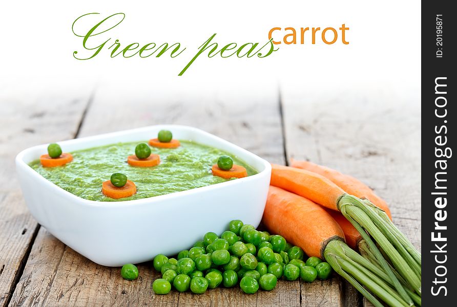 Fresh vegetable dish of green peas with carrots, place for your text up