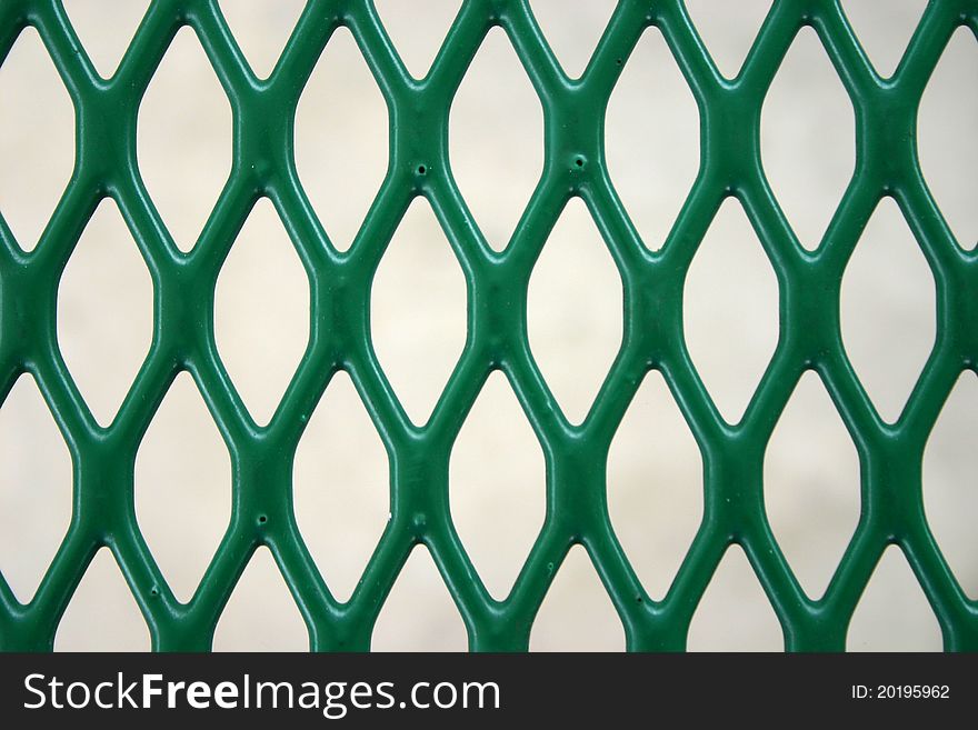 The grid of a green picnic table top. The grid of a green picnic table top