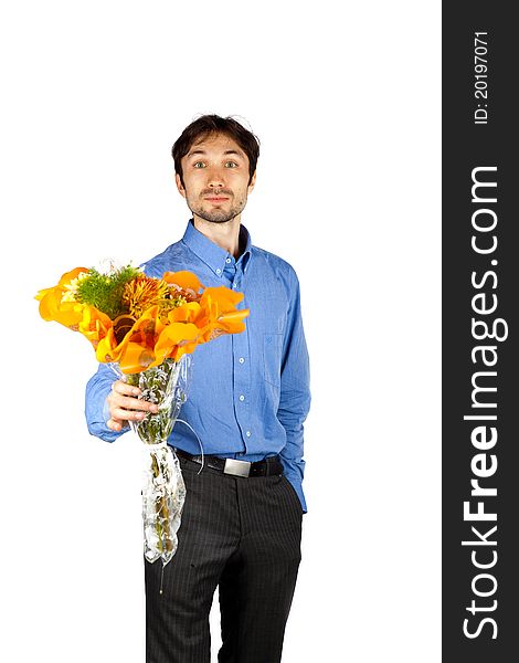 Nice man in a blue shirt with orange bristles standing with a bunch of flowers and smiling