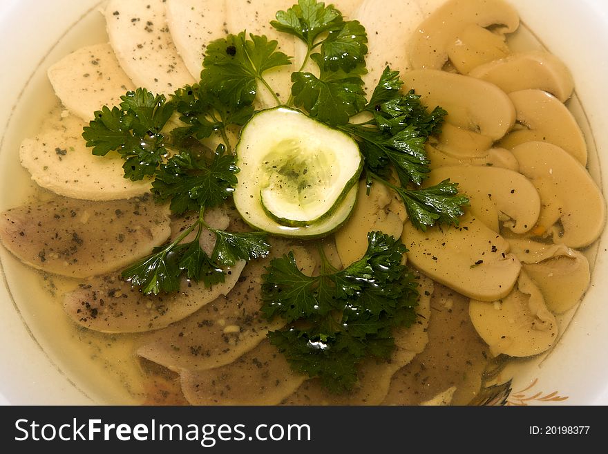 Aspic from meat decorated with cucumber and parsley