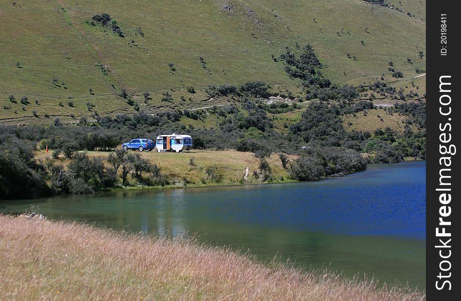 A family caravan camping beside Lake Moke, New Zealand. A family caravan camping beside Lake Moke, New Zealand.