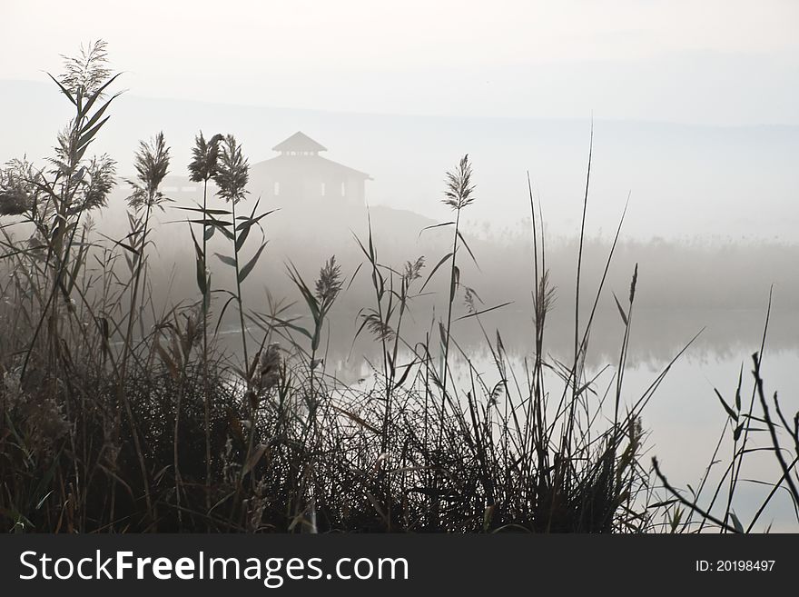 House in the fog at reservation during a sunrise