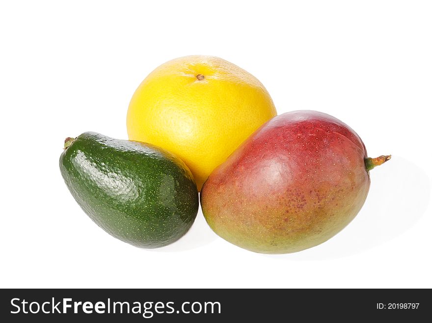 Mix of fresh tropical fruits isolated on white (avocado, grapefruit, mango). Mix of fresh tropical fruits isolated on white (avocado, grapefruit, mango)