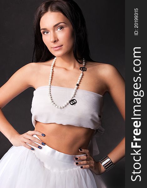 Young woman in white outfit isolated on black