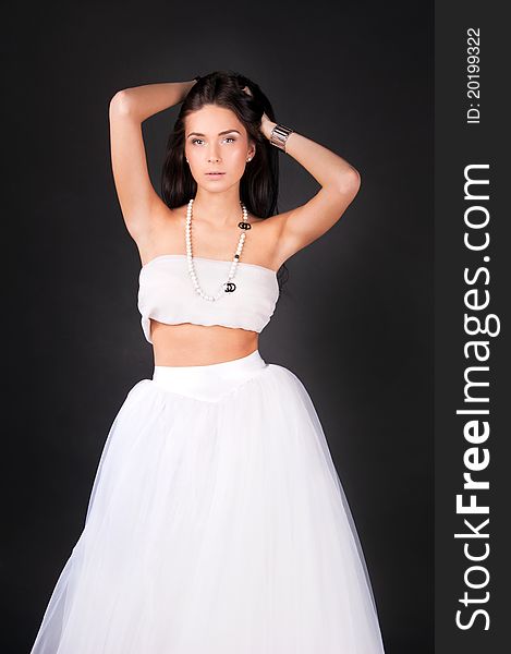 Young woman in white outfit isolated on black