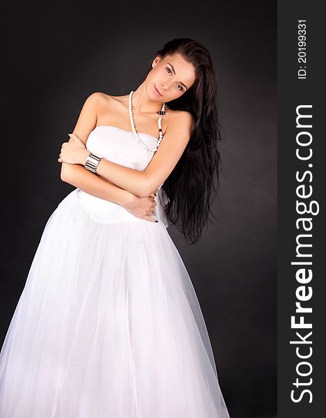 Young woman in white outfit isolated on black