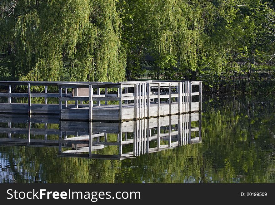 Boat dock sits in the middle of a pond.