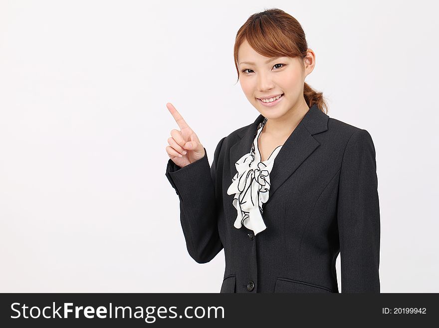 Smiling business woman rise hand and pointing