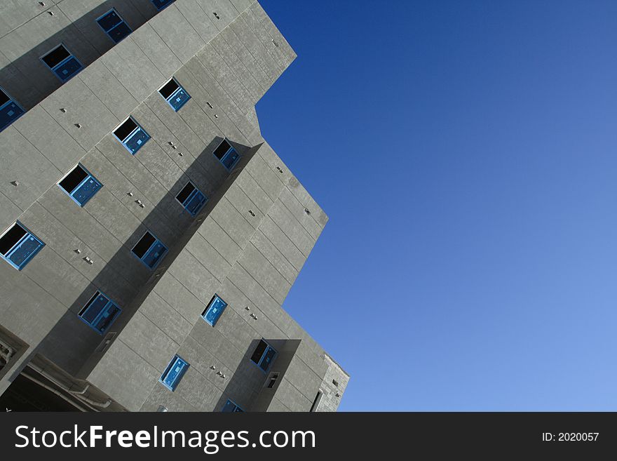 Building under construction with a deep blue sky in background. Abstract angle photo. Building under construction with a deep blue sky in background. Abstract angle photo.