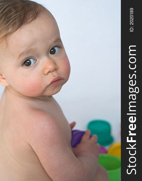 Image of adorable baby playing with stacking cups. Image of adorable baby playing with stacking cups