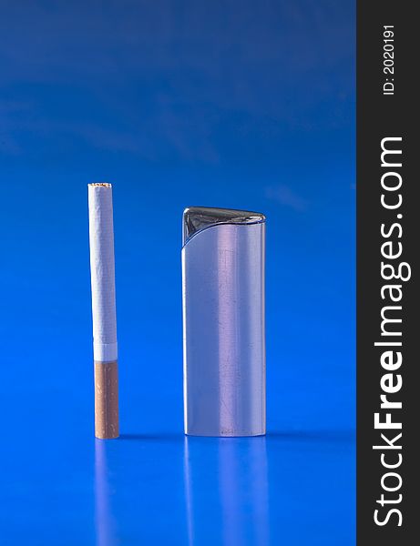 Cigarette and lighter isolated on blue background