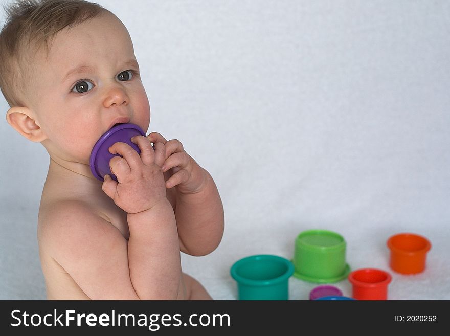 Image of adorable baby playing with stacking cups. Image of adorable baby playing with stacking cups