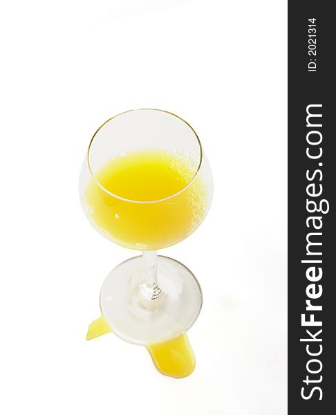 Fresh brightly orange juice in glass on a white background