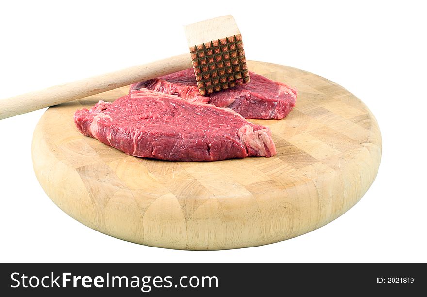 Tenderized Steak on a chopping board on a white background. Tenderized Steak on a chopping board on a white background