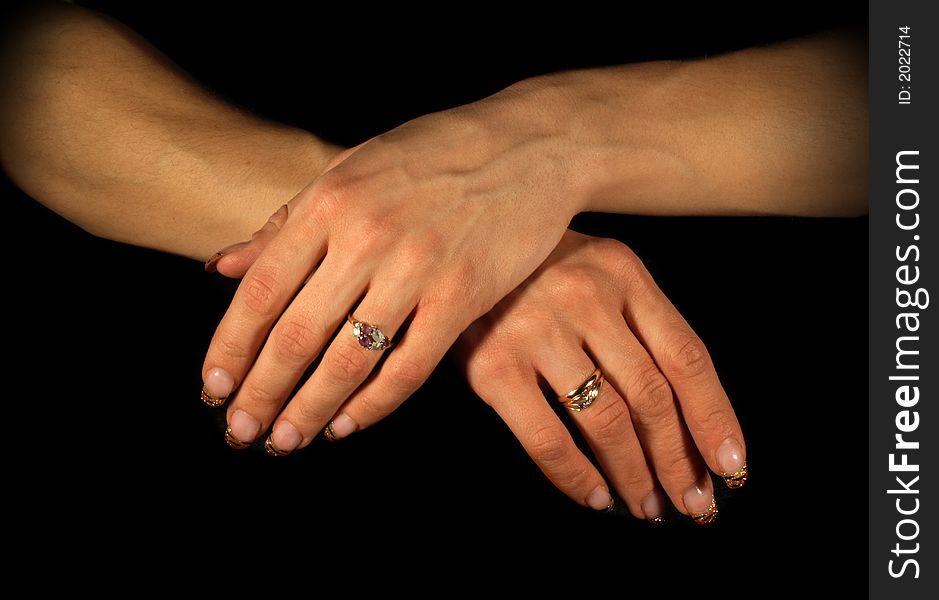 Female hands isolated on black, tungsten lighting used. Female hands isolated on black, tungsten lighting used