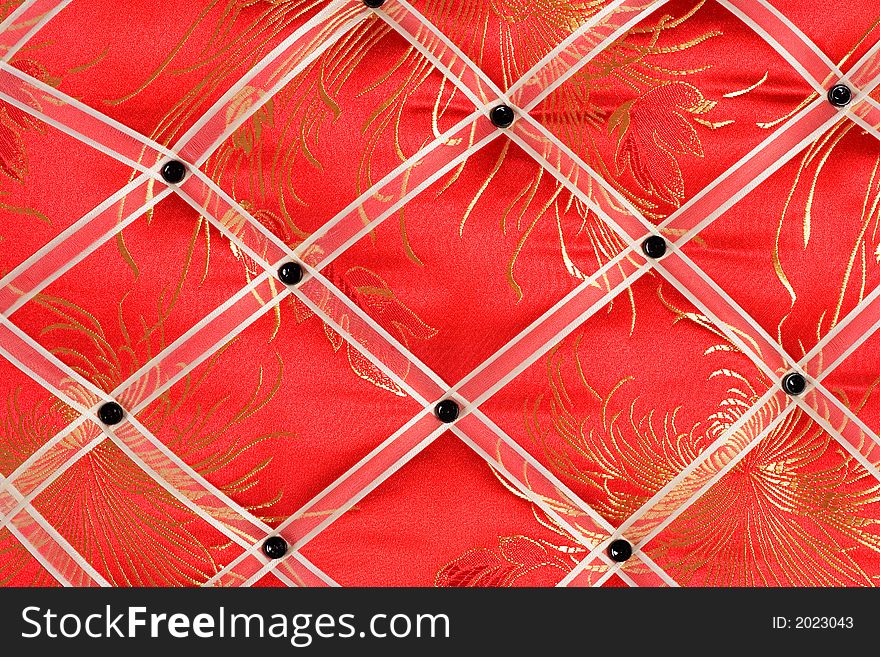 Close-up of a red memo board with white band and black button