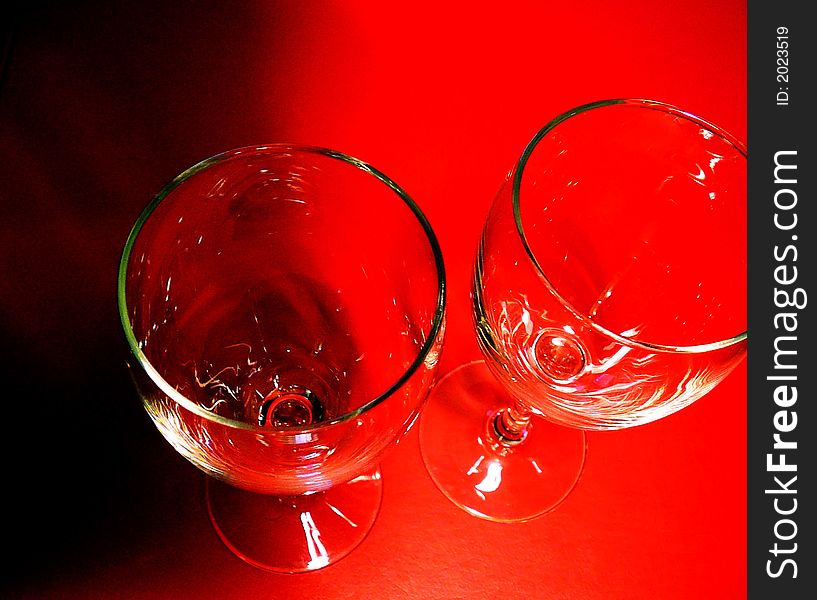 Pair of Wine Glasses Against Red and Black Background. Pair of Wine Glasses Against Red and Black Background