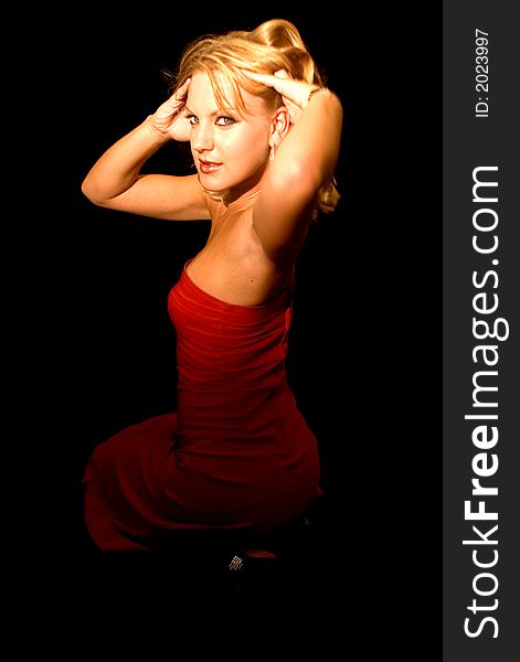 A sexy female wearing red dress against black background